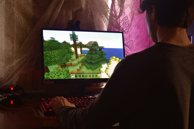 An image of a boy playing video game for digital product ideas